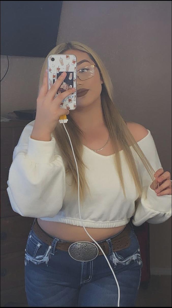 a woman is holding a wii remote and playing a video game