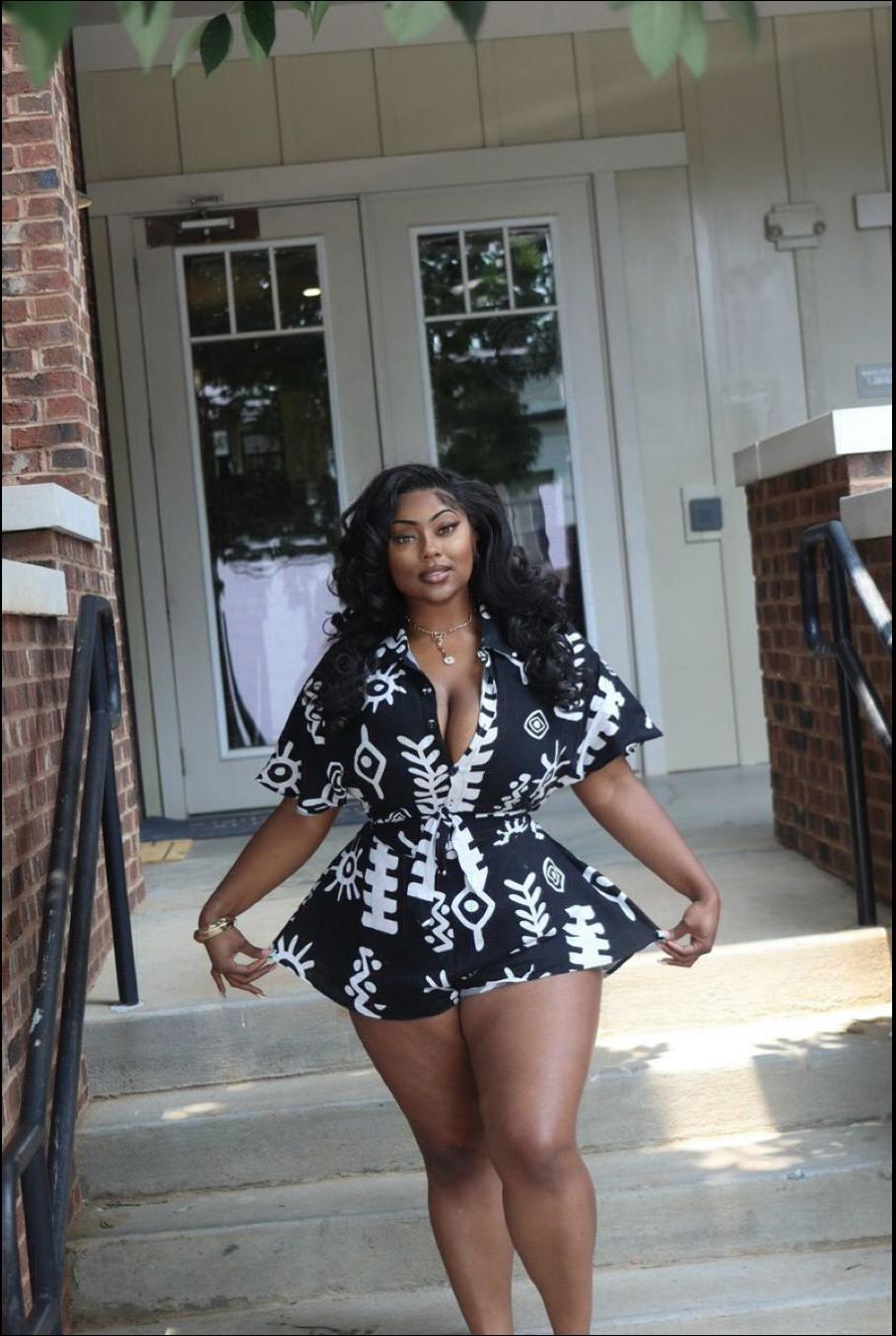 a woman in a red dress is walking down the street