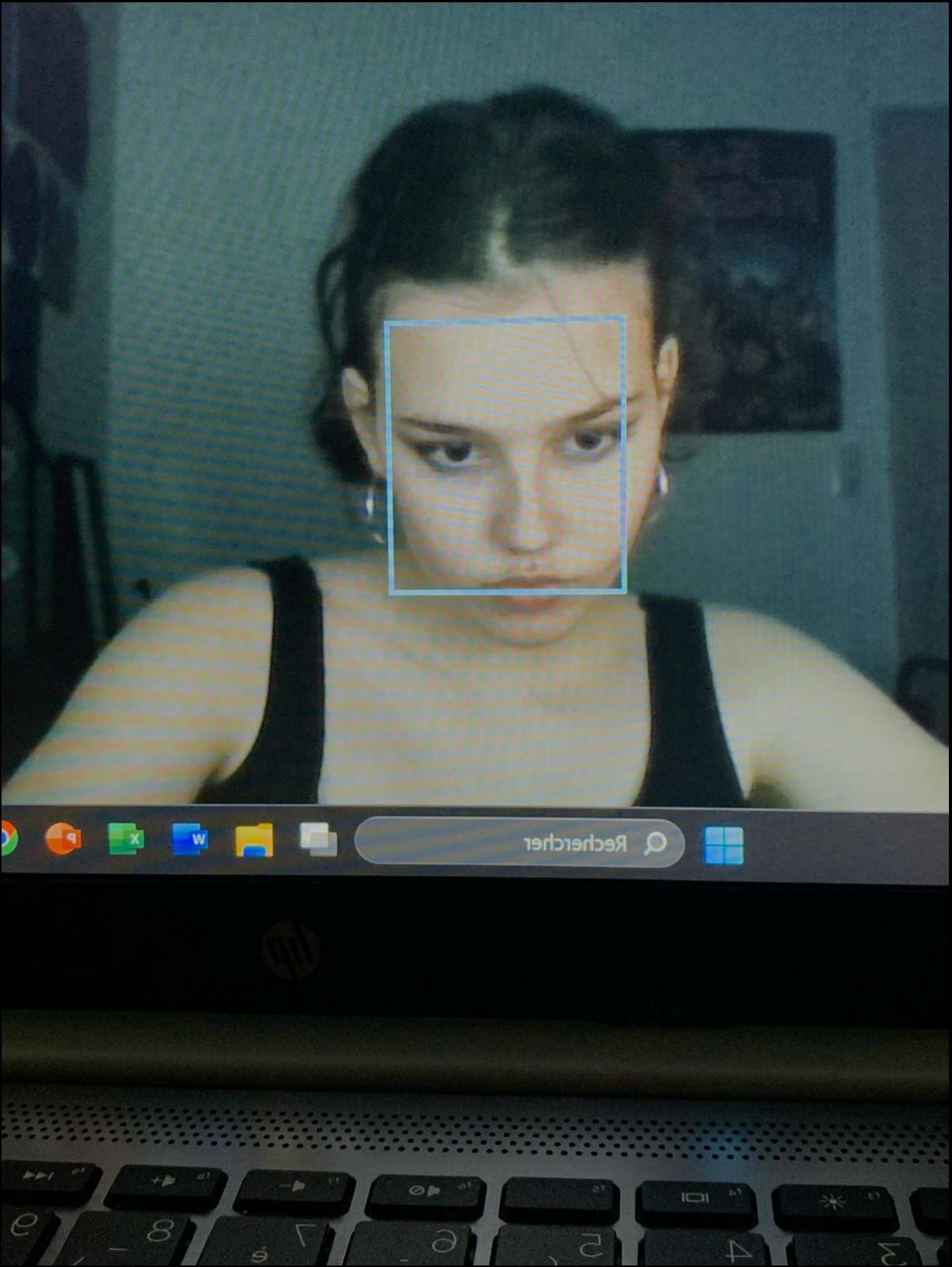 a woman is looking at a laptop on a tv