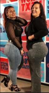 a woman and a man are standing in front of a sign