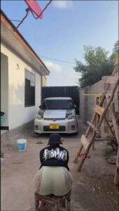 a man is sitting on a bed with a suitcase