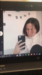 a woman is holding a cell phone and a picture of a woman