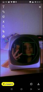 a person taking a picture of a microwave