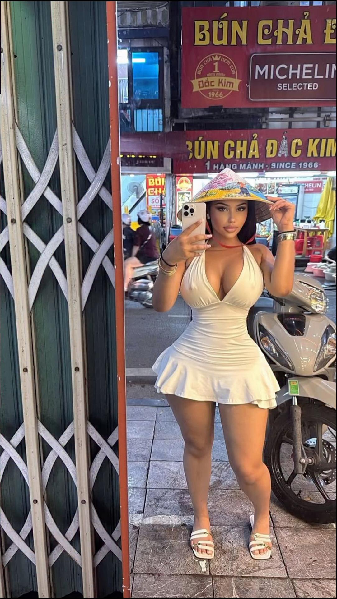 a woman is standing outside a building with a cell phone