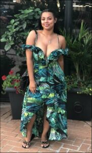 a woman in a blue dress standing in front of a flower pot