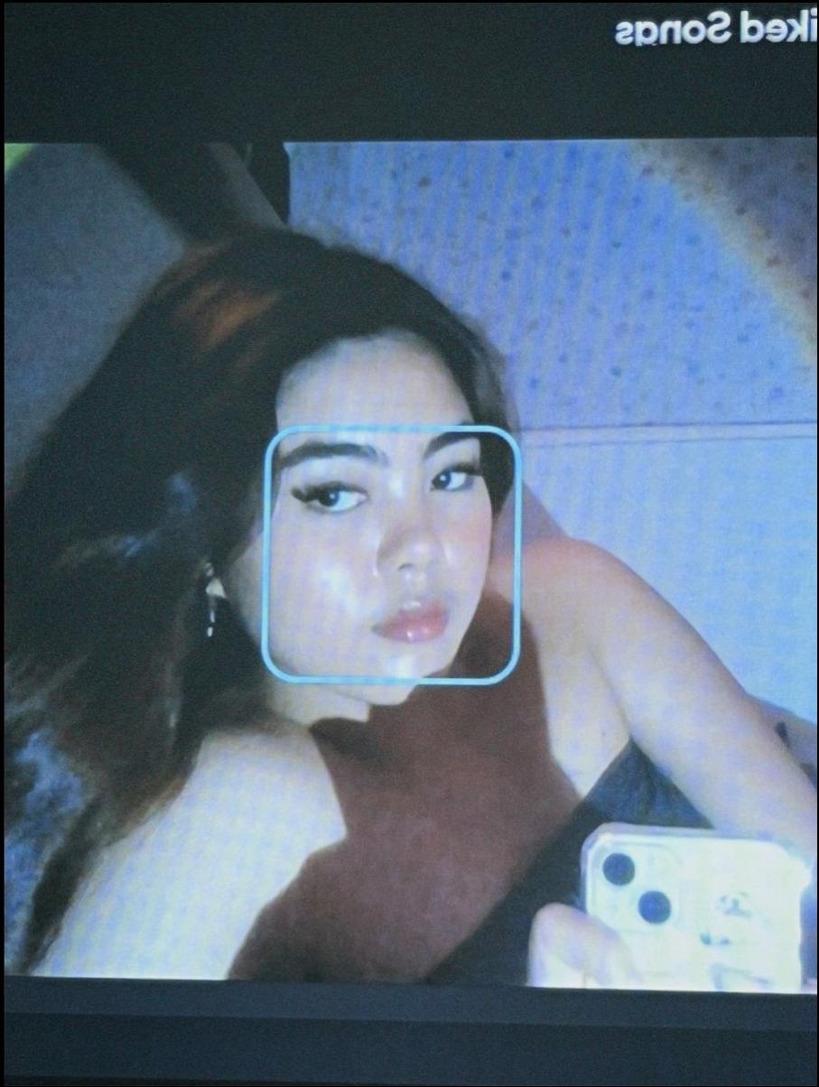 a woman is looking at a tv screen