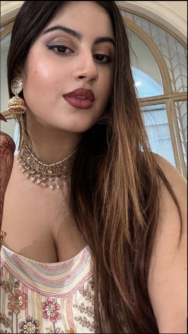 a woman with a red hair and a blue tie