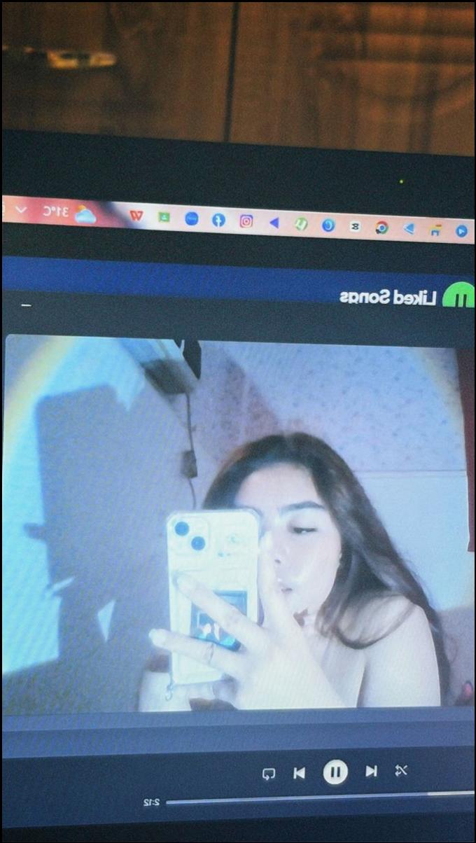 a woman is holding a laptop and a tv