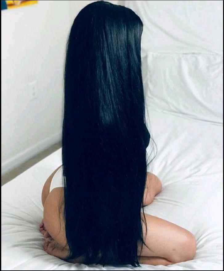 a woman is laying on a bed with a black and white background
