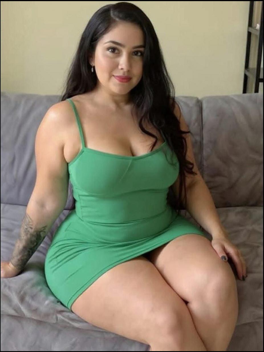 a woman is sitting on a couch with a green towel