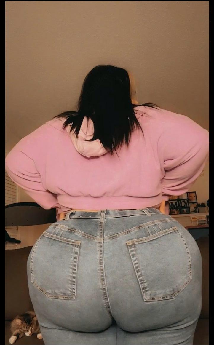 a woman sitting on a brown couch with a blue and white striped shirt