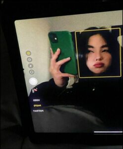 a person holding a remote control in front of a tv