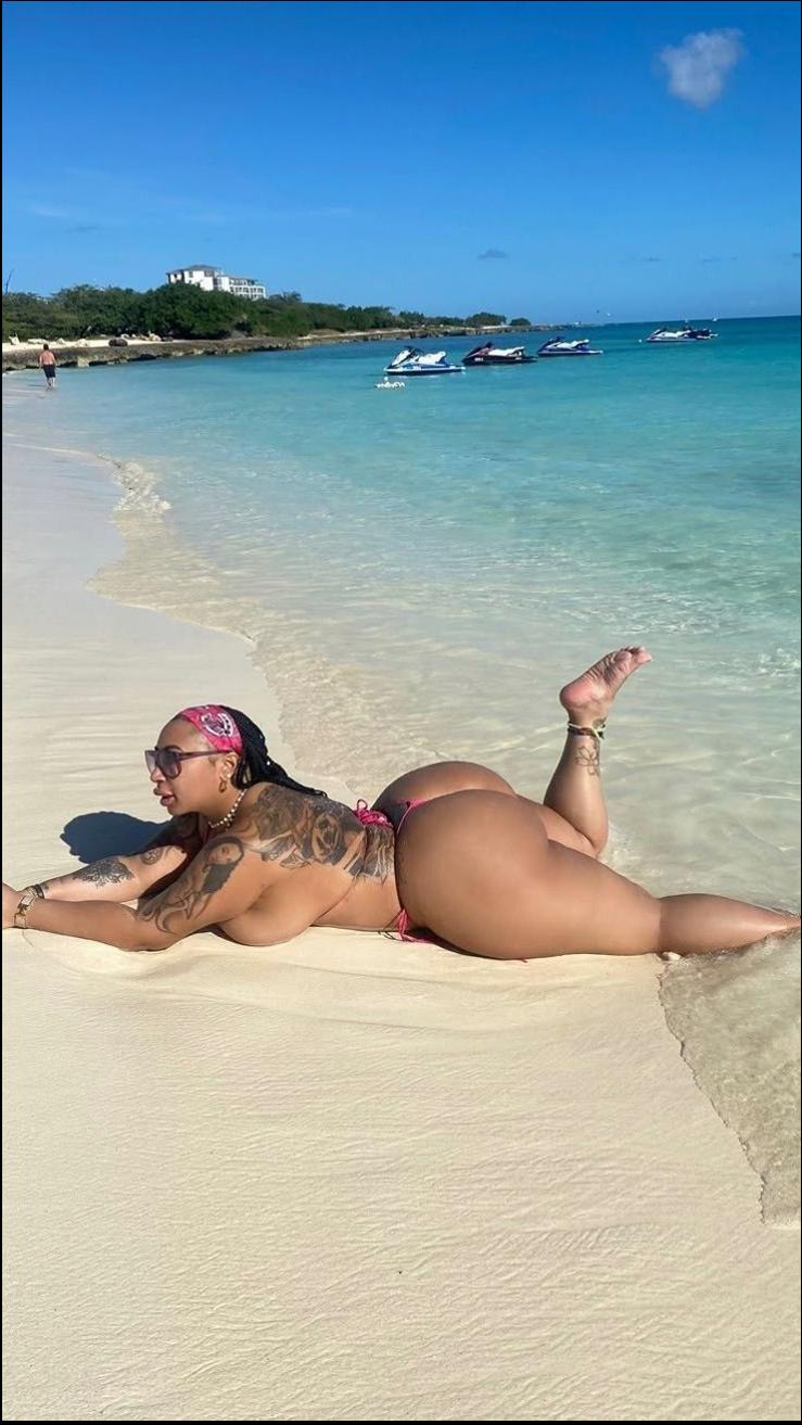 a woman laying on a beach with a surfboard