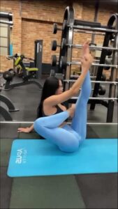 a woman is laying on a blue and white surfboard