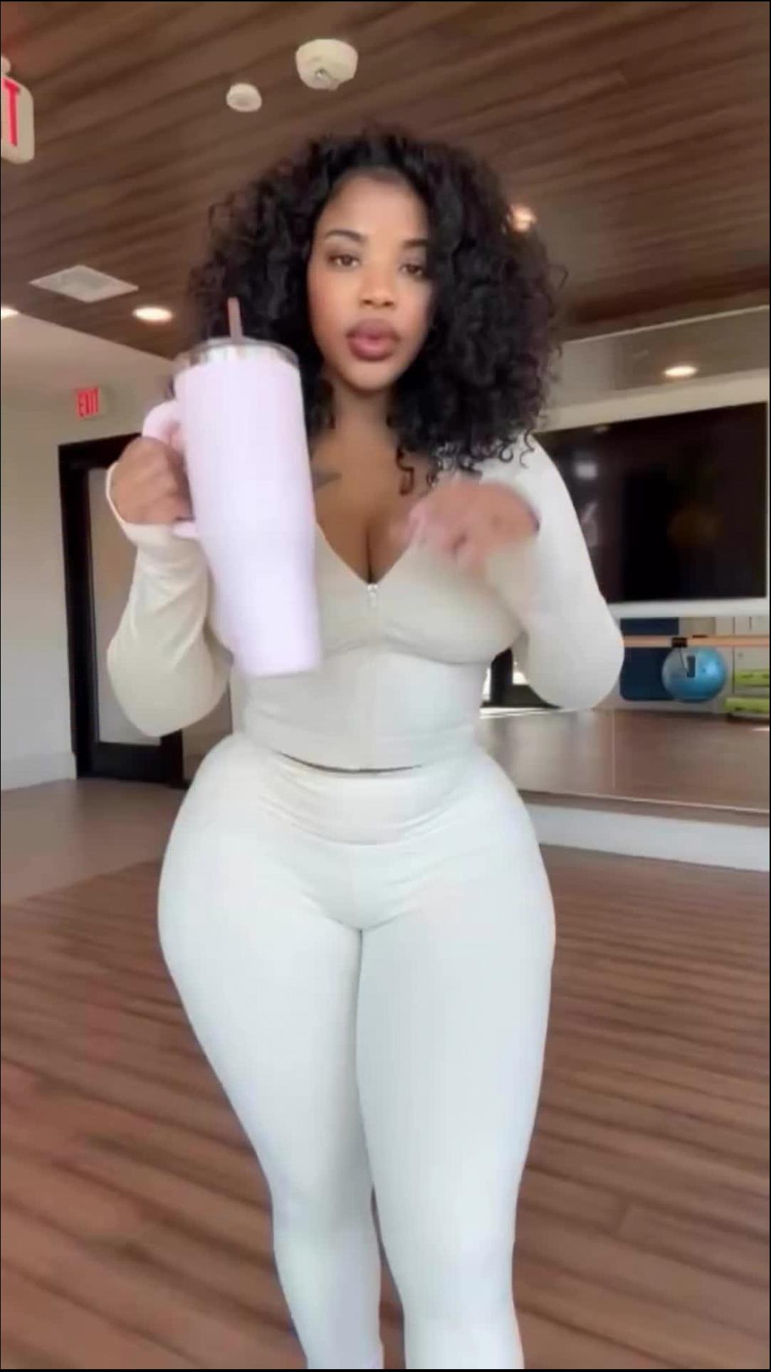 a woman is holding a white object in her hand