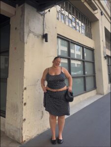 a woman is standing outside a building with a cell phone