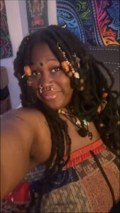 a woman with a red hair and a black top