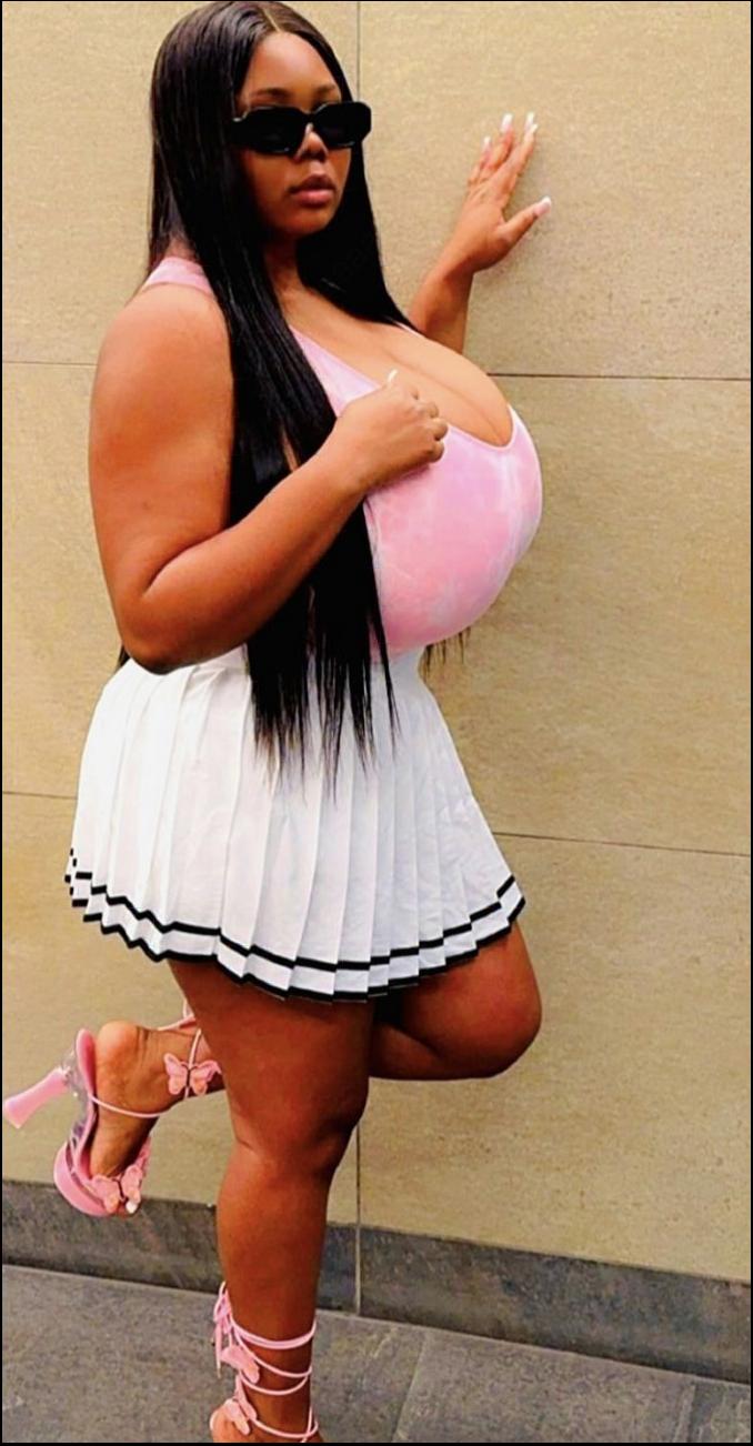 a woman in a pink dress is holding a pink and white object