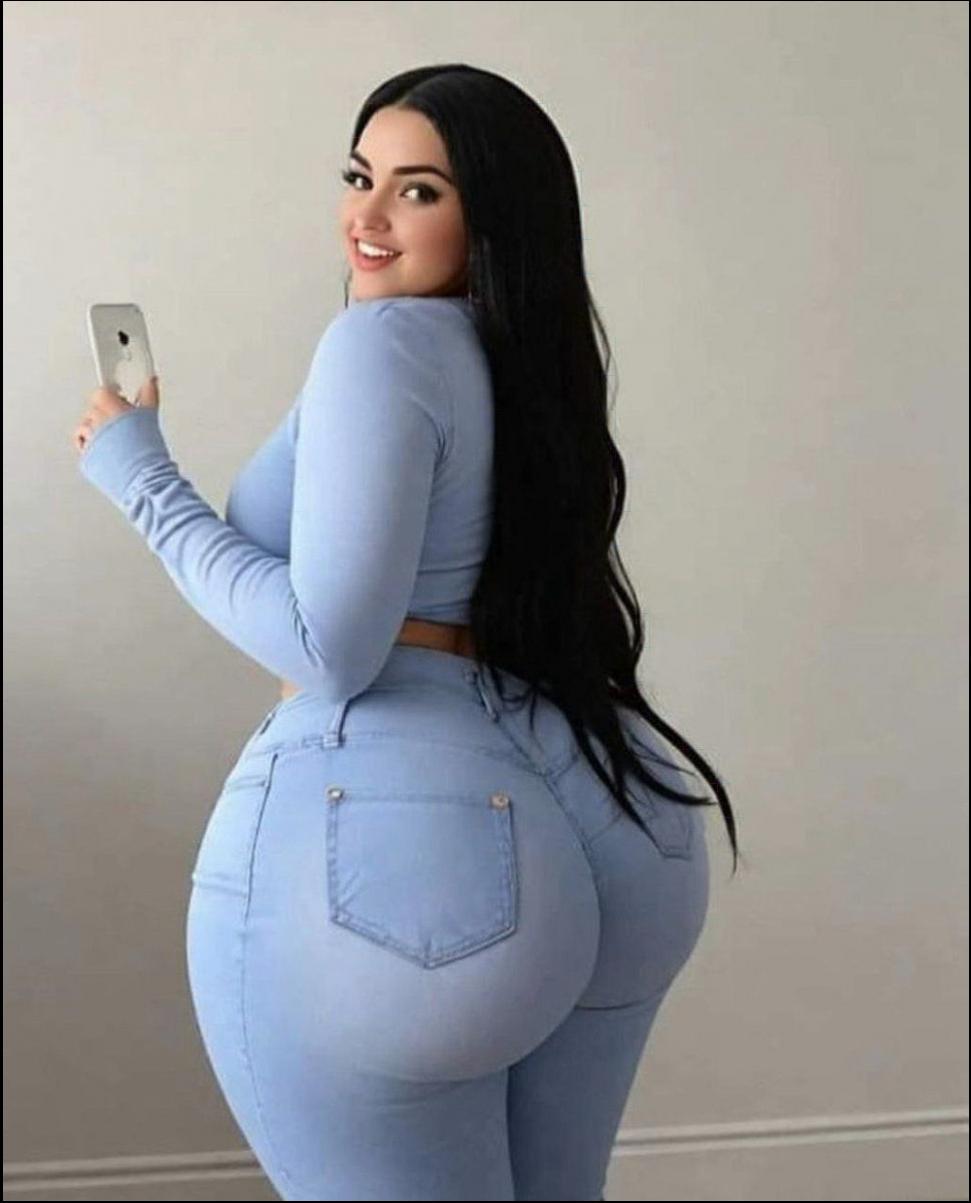 a woman in a blue shirt and blue shorts holding a white object