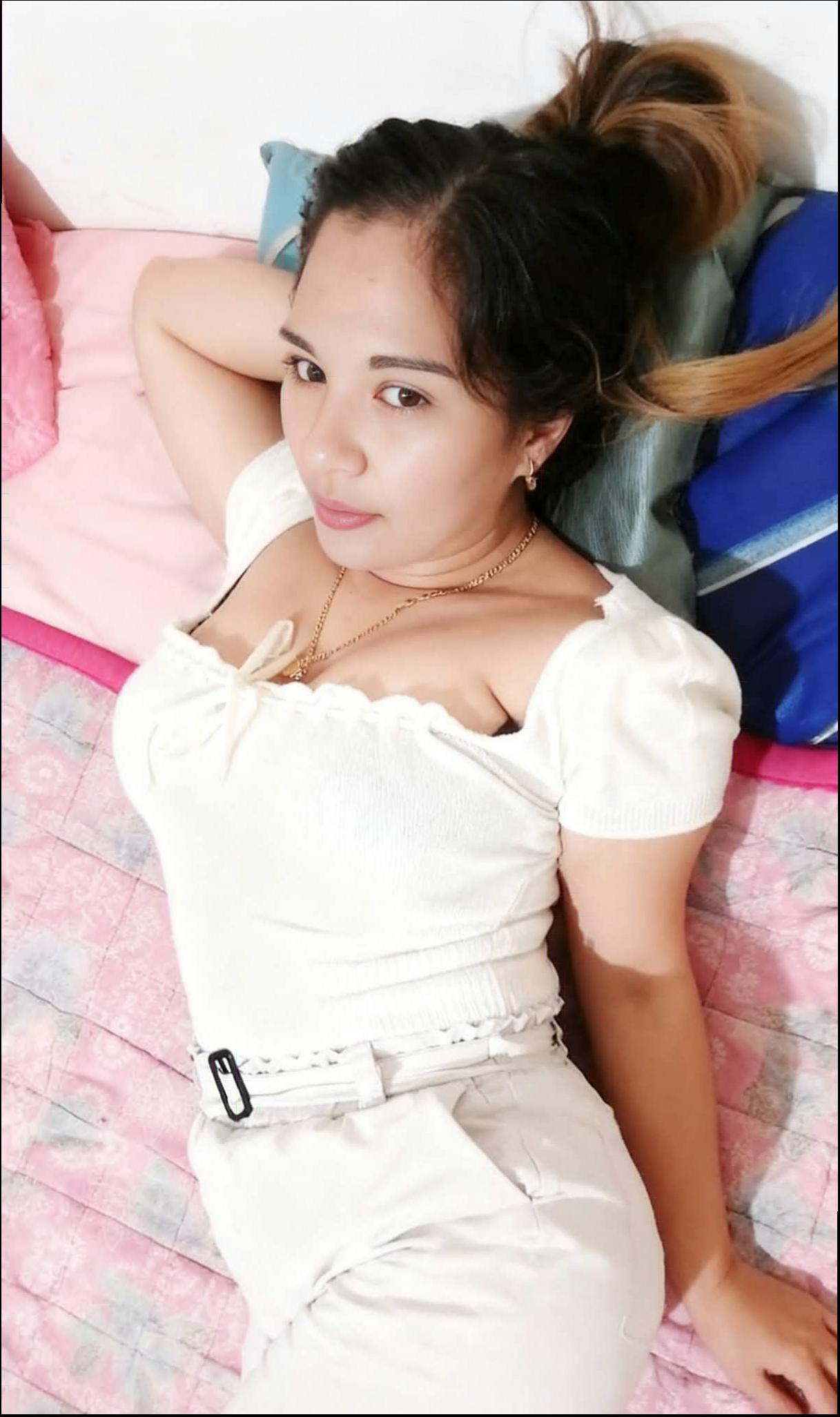 a woman is laying on a bed with a red blanket