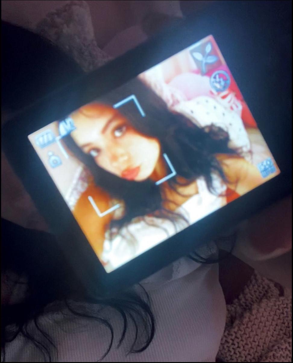 a woman is holding a wii remote