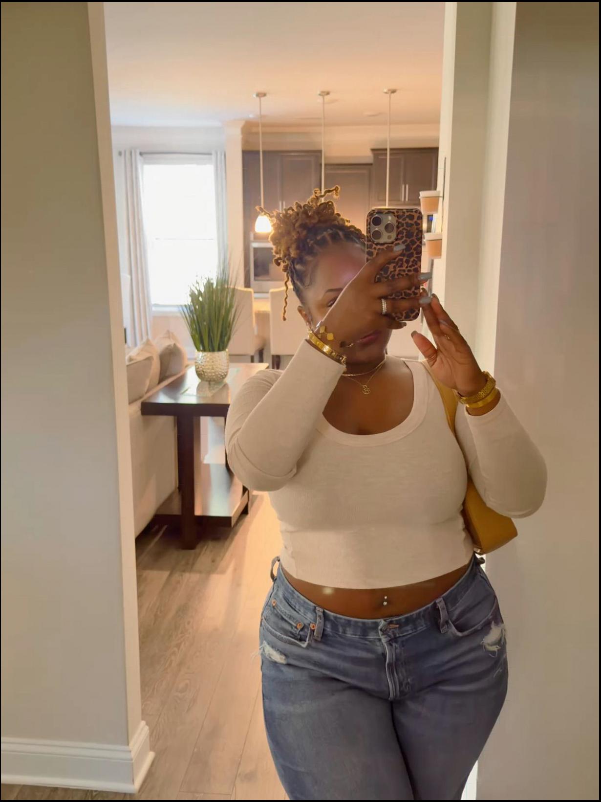 a woman holding a camera in a room