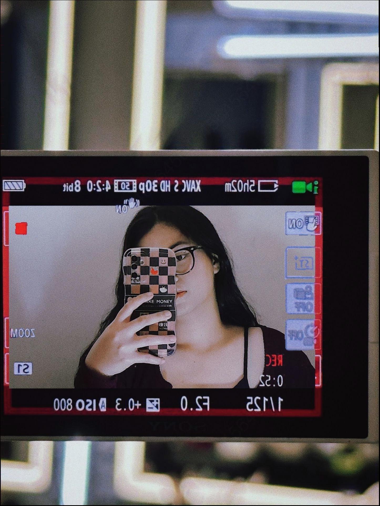 a woman is holding a tv remote