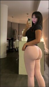 a woman is holding a cell phone in a bathroom