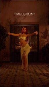 a woman in a black dress holding a white object