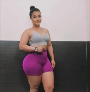 a woman is holding a cell phone in her hand