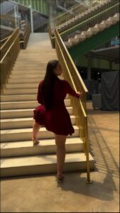 a woman is walking down a stairway