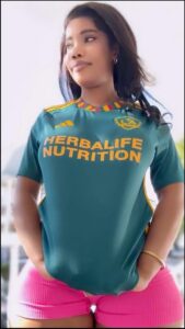 a woman wearing a pink shirt and a blue and white striped shirt