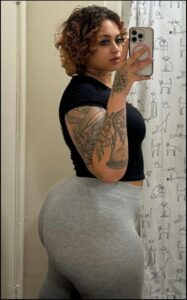 a woman taking a picture of herself in a mirror