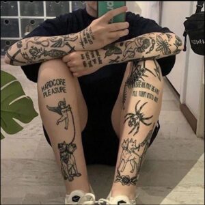 a woman with a tattoo on her face is laying on a sidewalk