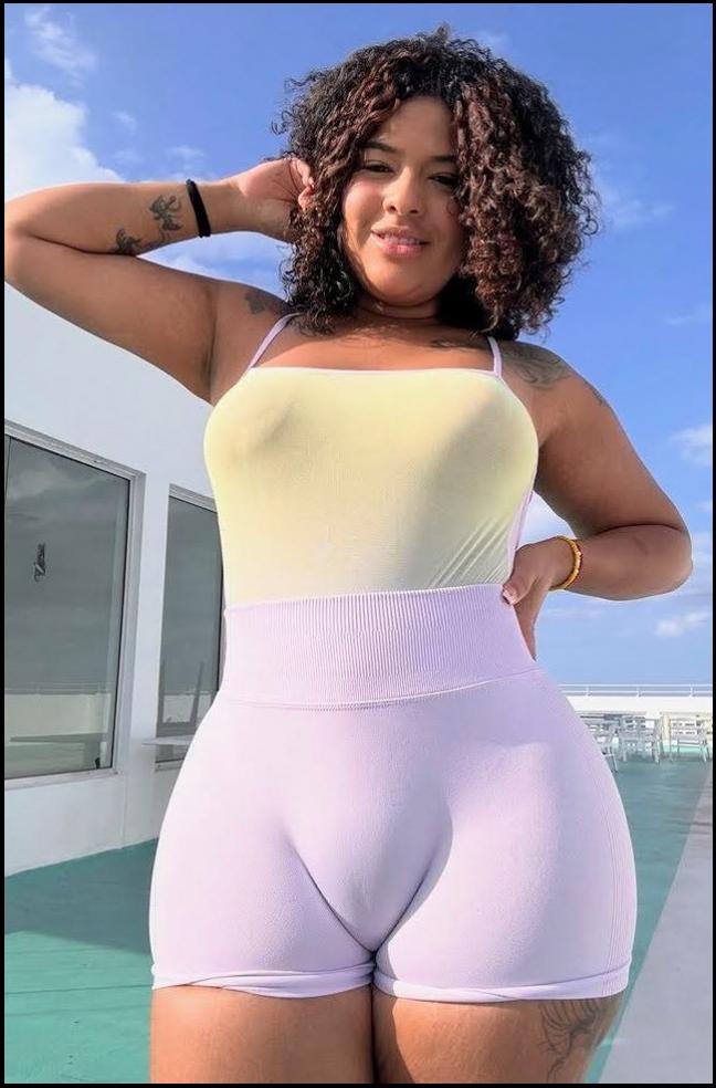 a woman in a pink shirt and a black skirt