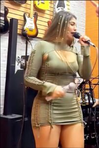 a woman in a pink dress is on a cell phone