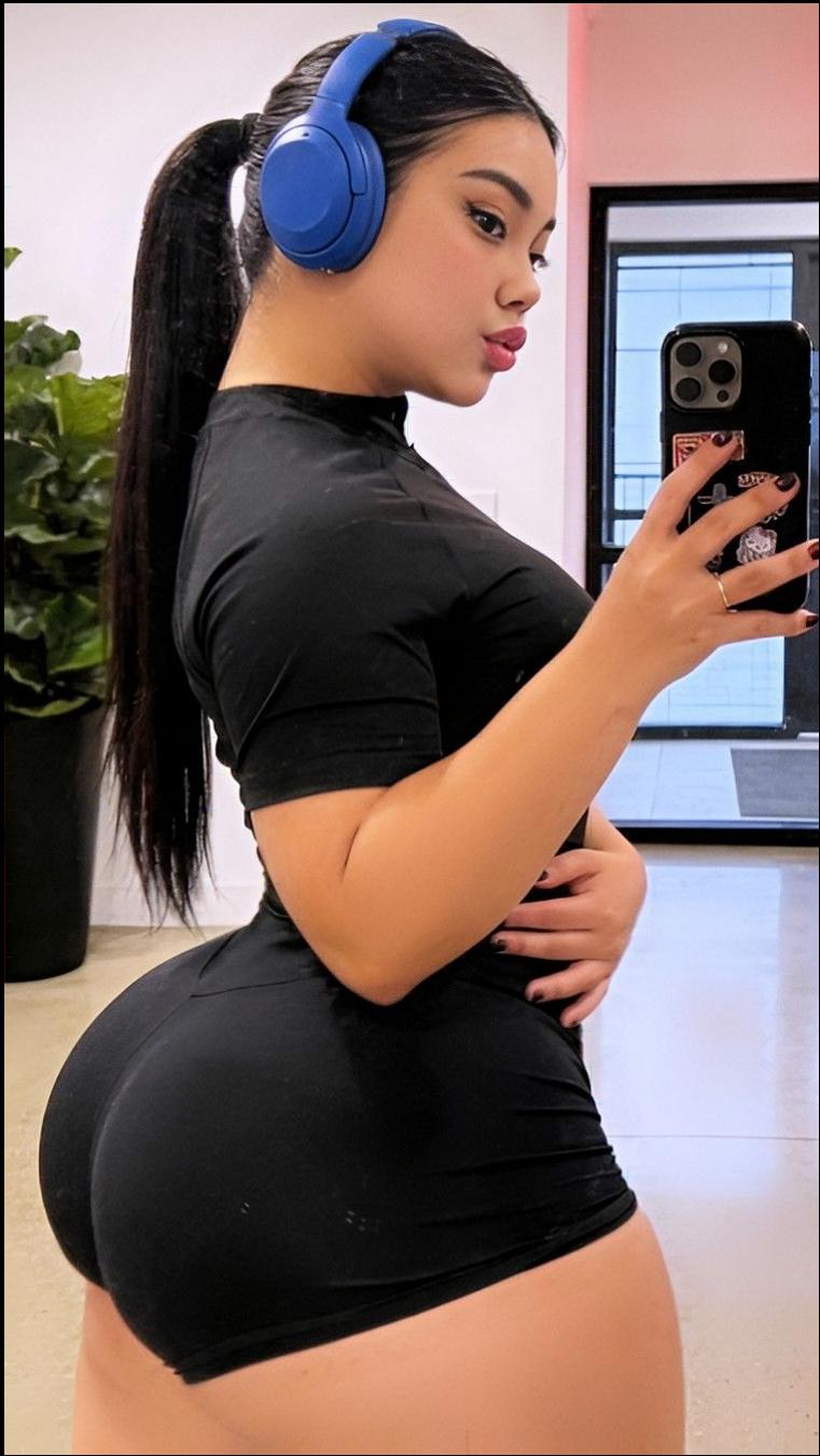 a woman is holding a cell phone in front of a mirror