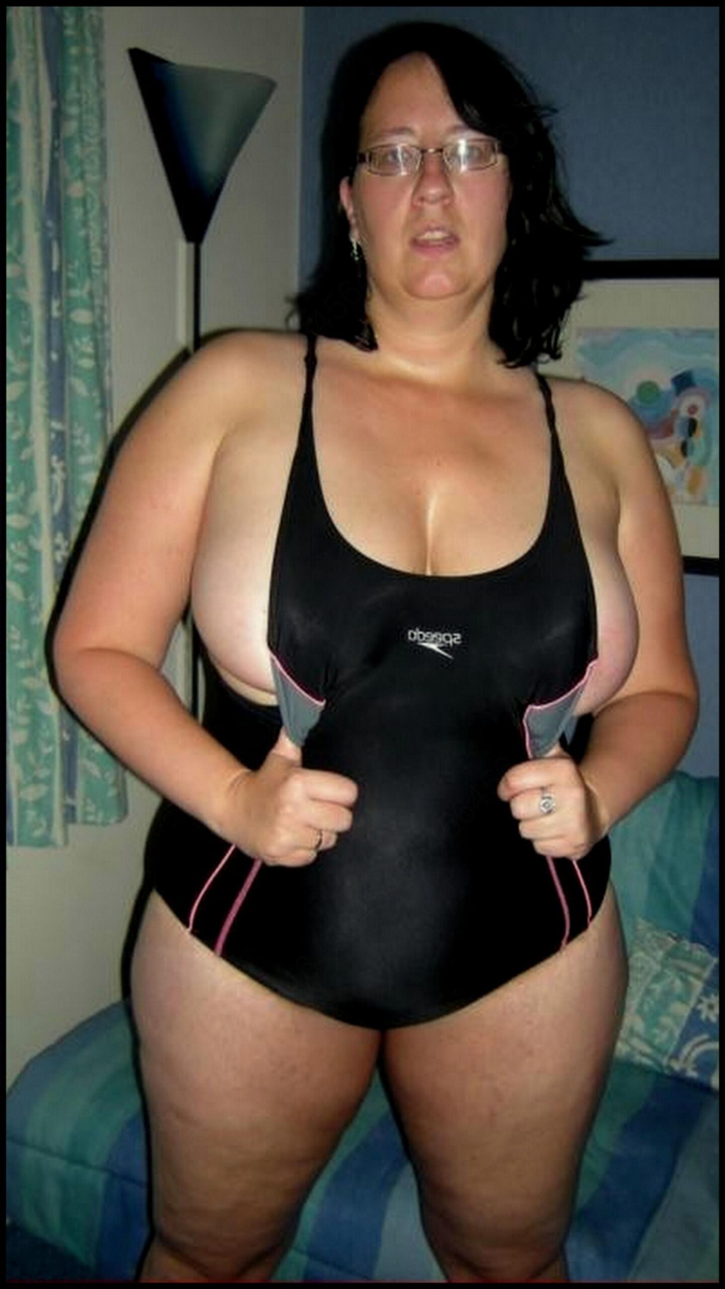 a woman in a bikini holding a cell phone