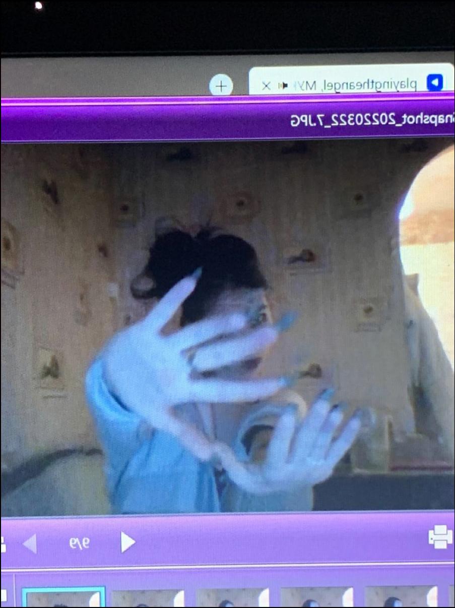 a woman is looking at a tv screen