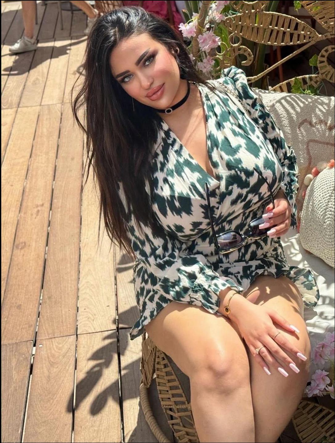 a woman sitting on a wooden bench