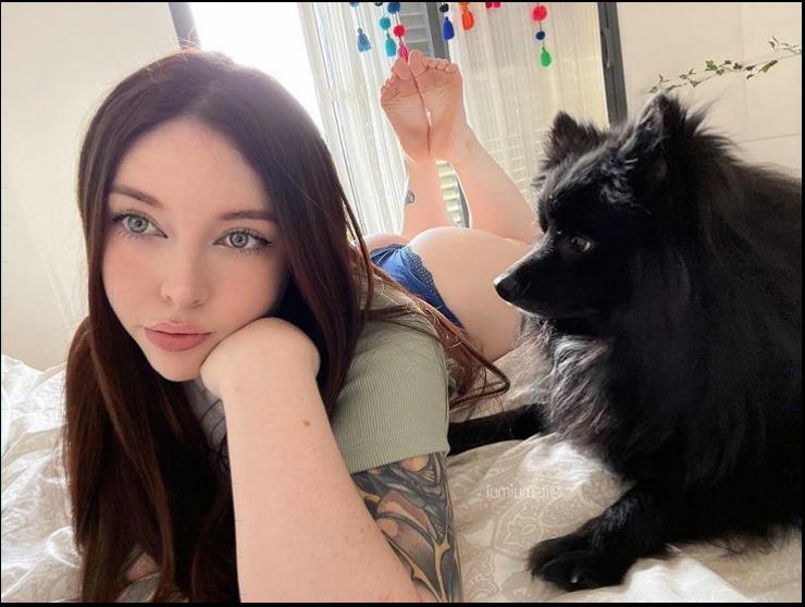 a woman sitting on a bed with a cat