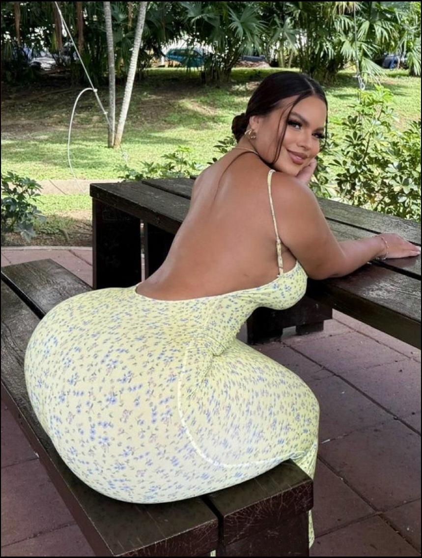 a woman laying on a bench with a large stuffed animal