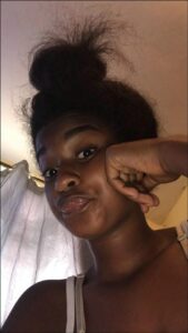 a woman is smiling and holding a cell phone