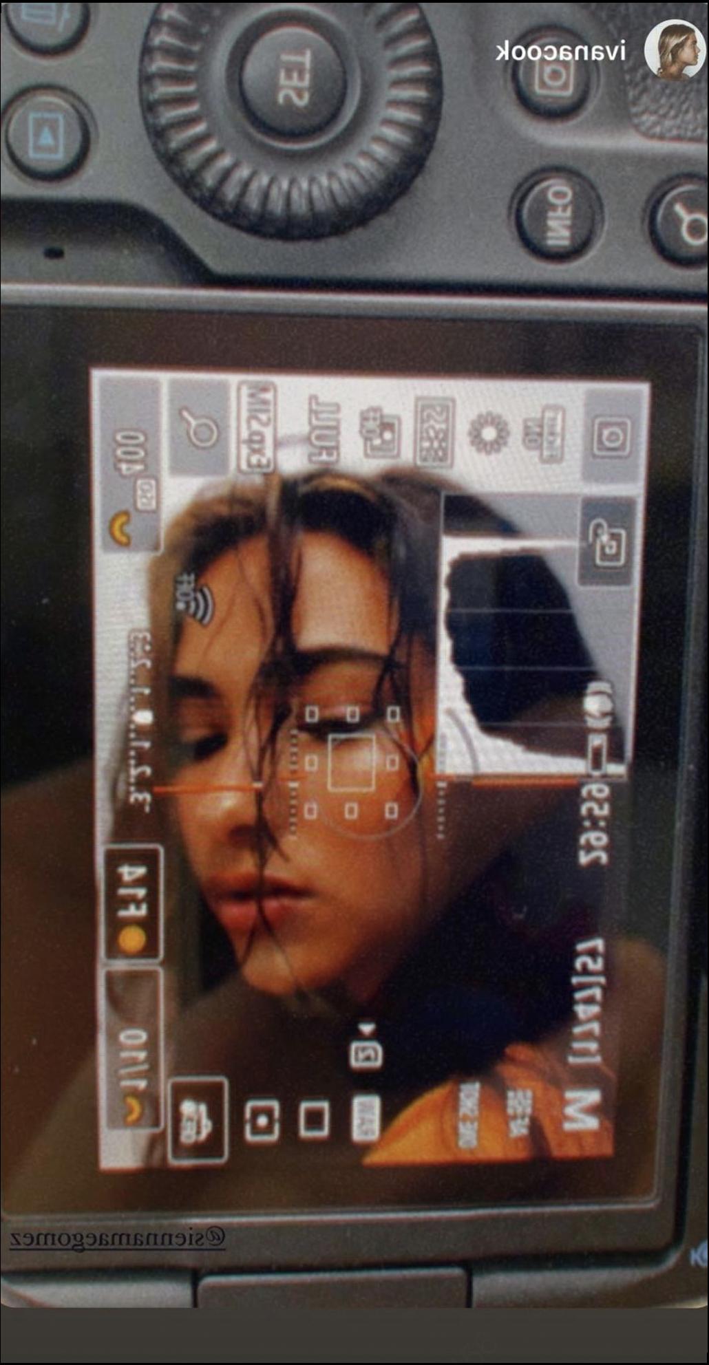 a camera is on a wall with a picture of a person