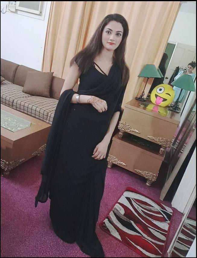 a woman in a red dress standing in a room