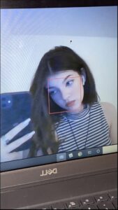 a woman is sitting on a tv and looking at a tv screen