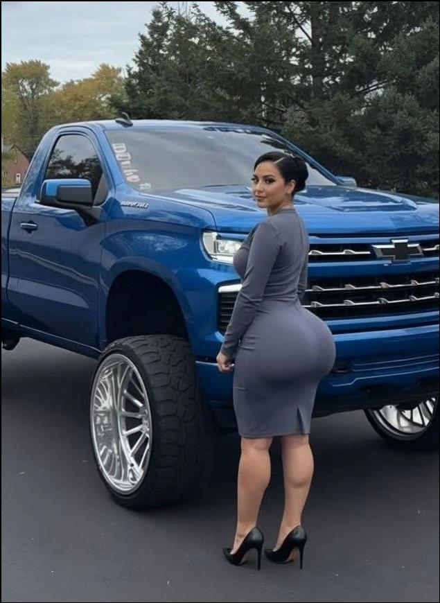 a woman standing next to a white truck
