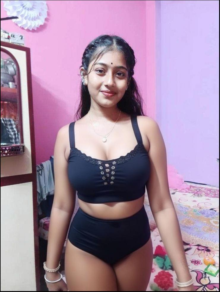 a woman in a pink shirt and blue skirt posing for a picture