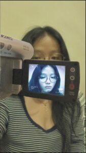 a woman holding a remote control in front of a tv