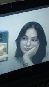 a woman is looking at a tv screen